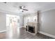 Bright living room with stone fireplace, ceiling fan, gray walls and wood-look tile flooring throughout at 4347 9Th N Ave, St Petersburg, FL 33713