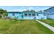 Well-maintained home exterior with lush green grass and access to a private backyard at 4512 26Th S Ave, Tampa, FL 33619