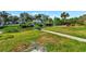 Waterfront backyard featuring a tranquil canal, lush greenery, and outdoor seating area perfect for relaxing at 4512 26Th S Ave, Tampa, FL 33619