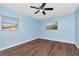 Cozy bedroom with modern flooring, light walls, a ceiling fan, and windows providing natural light at 4512 26Th S Ave, Tampa, FL 33619