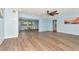 Bright open-concept living room with recessed lighting, ceiling fan, light walls, and attractive wood-look floors at 4512 26Th S Ave, Tampa, FL 33619