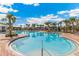 Spacious community pool area featuring clear blue water, lounge chairs, and shade structures for residents' enjoyment at 4517 Dusky Dawn Ln, Palmetto, FL 34221
