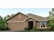 Charming single-story home with a two-car garage, landscaped front yard, and attractive curb appeal at 4517 Dusky Dawn Ln, Palmetto, FL 34221