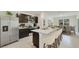 Modern kitchen with stainless steel appliances, an island with bar seating, and an adjacent dining area at 4517 Dusky Dawn Ln, Palmetto, FL 34221
