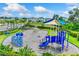 Vibrant community playground featuring climbing structures, slides, and swings for outdoor fun and recreation at 4517 Dusky Dawn Ln, Palmetto, FL 34221