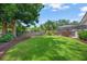 Lush backyard featuring a well-maintained lawn, mature trees, and a screened-in patio, perfect for outdoor relaxation at 4636 Pine Harrier Dr, Sarasota, FL 34231