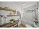 Bright bathroom with a tub-shower combo featuring stylish tile and decorative shelving at 4636 Pine Harrier Dr, Sarasota, FL 34231