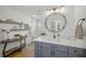 Elegant bathroom featuring a modern vanity, shiplap accent wall, and decorative shelves at 4636 Pine Harrier Dr, Sarasota, FL 34231