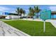 Lush green lawn and walkway leading to the building with a historical sign on Siesta Beach at 4636 Pine Harrier Dr, Sarasota, FL 34231