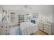 Cozy bedroom with white shiplap walls, wood floors, and natural light at 4636 Pine Harrier Dr, Sarasota, FL 34231