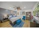 Comfortable bedroom with hardwood floors, fan, and closet at 4636 Pine Harrier Dr, Sarasota, FL 34231