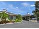 Community clubhouse featuring a covered entrance and well-maintained landscaping in a tropical setting at 4636 Pine Harrier Dr, Sarasota, FL 34231