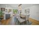 Stylish dining room with hardwood floors, a statement chandelier, and access to outdoor space at 4636 Pine Harrier Dr, Sarasota, FL 34231