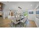 Spacious dining room with hardwood floors, modern chandelier, and views of the outdoors at 4636 Pine Harrier Dr, Sarasota, FL 34231