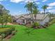 Stunning home featuring vibrant landscaping, pristine lawn, brick driveway, and a classic white facade at 4636 Pine Harrier Dr, Sarasota, FL 34231
