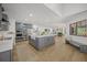 Bright, open kitchen with gray cabinets, a large island, stainless steel appliances, and a view of living room at 4636 Pine Harrier Dr, Sarasota, FL 34231