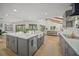Stylish kitchen with an island, gray cabinets, hardwood floors, and an open layout to the living room at 4636 Pine Harrier Dr, Sarasota, FL 34231