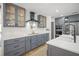 Well-designed kitchen featuring grey cabinets, ample counter space, and modern appliances for a chef's dream at 4636 Pine Harrier Dr, Sarasota, FL 34231