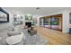 Comfortable living room featuring a fireplace, hardwood floors, stylish decor, and sliding glass doors with views of the pool at 4636 Pine Harrier Dr, Sarasota, FL 34231
