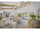 Open living area with hardwood floors, vaulted ceilings and access to outdoor pool and patio at 4636 Pine Harrier Dr, Sarasota, FL 34231
