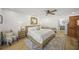 Well-lit main bedroom with hardwood floors, wood accent wall, and ensuite bath at 4636 Pine Harrier Dr, Sarasota, FL 34231
