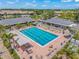 Aerial view of a large swimming pool and deck with lounge chairs and manicured landscaping at 4636 Pine Harrier Dr, Sarasota, FL 34231