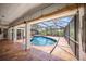 Stunning pool within a screened enclosure, complemented by a brick patio and lush landscaping at 4636 Pine Harrier Dr, Sarasota, FL 34231