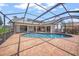 Beautiful pool featuring a screened enclosure and brick patio, perfect for outdoor entertainment at 4636 Pine Harrier Dr, Sarasota, FL 34231