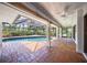 Inviting screened-in pool area with a brick patio, ideal for outdoor relaxation at 4636 Pine Harrier Dr, Sarasota, FL 34231