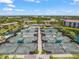 Aerial view of tennis courts with pristine green surfaces and well-maintained landscaping at 4636 Pine Harrier Dr, Sarasota, FL 34231
