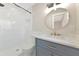 Bathroom features a modern vanity, round mirror, walk-in shower, and tiled walls at 4812 21St W St, Bradenton, FL 34207