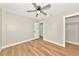 Bedroom with light walls, wood-look flooring, ceiling fan, and closet at 4812 21St W St, Bradenton, FL 34207