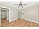 Bright bedroom boasts wood-look flooring, ceiling fan, and closet with natural light at 4812 21St W St, Bradenton, FL 34207