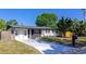 Quaint home featuring a blue front door, black accents, and a beautifully landscaped yard at 4812 21St W St, Bradenton, FL 34207