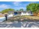 Lovely single-story home featuring a blue front door, manicured lawn, and a black mailbox at 4812 21St W St, Bradenton, FL 34207
