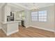 Kitchen and dining area featuring hardwood floors, white cabinets and stainless steel appliances at 4812 21St W St, Bradenton, FL 34207