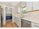 Kitchen featuring white cabinets, gold hardware, and a view into the laundry room at 4812 21St W St, Bradenton, FL 34207