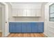 Bright kitchen features two-tone cabinets, gold hardware, stylish backsplash, and wood-look flooring at 4812 21St W St, Bradenton, FL 34207