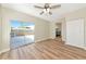 Living room featuring wood-look flooring, sliding glass door, and access to the kitchen at 4812 21St W St, Bradenton, FL 34207