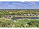 A community aerial view of properties surrounding a scenic lake and a golf course at 5217 Chase Oaks Dr, Sarasota, FL 34241