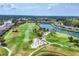 Expansive aerial view of a golf course with water features, sand traps and lush fairways at 5217 Chase Oaks Dr, Sarasota, FL 34241