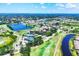 Expansive aerial view of the community featuring golf courses, lakes, and tennis courts at 5217 Chase Oaks Dr, Sarasota, FL 34241