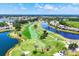 Breathtaking aerial view of a scenic golf course with winding paths, lakes, and lush landscapes at 5217 Chase Oaks Dr, Sarasota, FL 34241