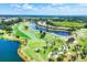 Aerial view of a scenic golf course with lush green fairways, sand traps, and a tranquil pond at 5217 Chase Oaks Dr, Sarasota, FL 34241
