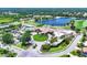Aerial view of the community clubhouse, pool, and surrounding golf course with lake at 5217 Chase Oaks Dr, Sarasota, FL 34241