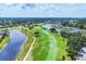 Expansive aerial view of a lush golf course with serene lakes and surrounding community at 5217 Chase Oaks Dr, Sarasota, FL 34241