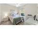 This bedroom offers comfort with a bright window providing natural light at 5217 Chase Oaks Dr, Sarasota, FL 34241