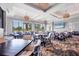 The community clubhouse dining area is well lit and features a television and beautiful views of the golf course at 5217 Chase Oaks Dr, Sarasota, FL 34241