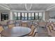 Well-appointed dining room with large curved windows offering scenic views of the surrounding landscape at 5217 Chase Oaks Dr, Sarasota, FL 34241