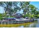 Close-up of the community entrance sign featuring brick accents and landscaping near a pond at 5217 Chase Oaks Dr, Sarasota, FL 34241